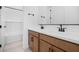 Bright bathroom features a double sink vanity with modern faucets and a tub with white subway tile at 37695 W Santa Maria St, Maricopa, AZ 85138