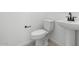 Modern bathroom with a pedestal sink, toilet, and fixtures; bright and clean at 37695 W Santa Maria St, Maricopa, AZ 85138