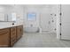 Bathroom features a walk-in shower, free-standing tub, and modern patterned flooring at 37695 W Santa Maria St, Maricopa, AZ 85138