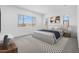 Bright bedroom with large windows, neutral decor, and a cozy rug at 37695 W Santa Maria St, Maricopa, AZ 85138