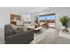 Open-concept living room with modern sofa, stylish furniture, and sliding glass doors providing natural light at 37695 W Santa Maria St, Maricopa, AZ 85138