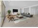Bright living room featuring stylish seating, modern decor, tile floors, and sliding glass doors at 37695 W Santa Maria St, Maricopa, AZ 85138