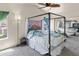 Spacious bedroom features a four poster bed, ceiling fan, and neutral carpet at 3871 W Linda Ln, Chandler, AZ 85226