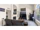 Open-concept living room with a fireplace, carpet, and natural light from a large window at 3871 W Linda Ln, Chandler, AZ 85226