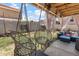 Relaxing backyard patio features egg swing chairs, comfortable blue wicker seating, and privacy curtains at 3871 W Linda Ln, Chandler, AZ 85226