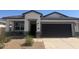 Charming single-story home with a covered porch and a two-car garage, complete with desert landscaping at 40015 W Venture Rd, Maricopa, AZ 85138