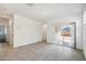 Open-concept living room with tiled floor and sliding glass doors at 40015 W Venture Rd, Maricopa, AZ 85138