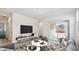 Bright living room with modern furniture and sliding glass door to backyard at 40015 W Venture Rd, Maricopa, AZ 85138
