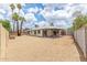 View of large, low-maintenance backyard with covered patio, mature trees, and perimeter fencing at 4226 W Evans Dr, Phoenix, AZ 85053