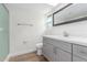 Modern bathroom features a skylight, new fixtures, and grey cabinetry at 4226 W Evans Dr, Phoenix, AZ 85053