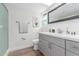 Modern bathroom features a skylight, new fixtures, and grey cabinetry at 4226 W Evans Dr, Phoenix, AZ 85053