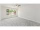 New carpet in the bedroom with a ceiling fan and a large window at 4226 W Evans Dr, Phoenix, AZ 85053