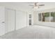 New carpet in the bedroom with a ceiling fan, large window, and a closet at 4226 W Evans Dr, Phoenix, AZ 85053