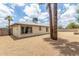 Rear exterior view of home and large backyard with easy-care desert landscaping, palms, and privacy fence at 4226 W Evans Dr, Phoenix, AZ 85053