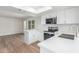 Bright kitchen features stainless appliances, wood floors, and modern white cabinets at 4226 W Evans Dr, Phoenix, AZ 85053