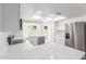 Modern white kitchen featuring quartz countertops, stainless steel appliances, and ample natural light at 4226 W Evans Dr, Phoenix, AZ 85053