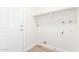This laundry room features fresh paint, overhead shelving, and vinyl flooring at 4226 W Evans Dr, Phoenix, AZ 85053