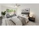 Stylized primary bedroom features a ceiling fan, two chairs and a large window at 4226 W Evans Dr, Phoenix, AZ 85053