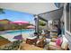 Expansive backyard features a covered patio, overhead shade, and lounge seating beside a large refreshing pool at 4231 E Augusta Ave, Chandler, AZ 85249