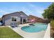 Lush backyard featuring a sparkling pool, inviting lounge chairs, and a covered patio at 4231 E Augusta Ave, Chandler, AZ 85249