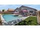 Beautiful backyard with a refreshing pool, shaded lounge area, and well-manicured lawn at 4231 E Augusta Ave, Chandler, AZ 85249