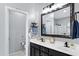Bright bathroom featuring double sinks, a large mirror, and access to the commode and shower area at 4231 E Augusta Ave, Chandler, AZ 85249