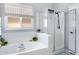 Bright bathroom featuring a large soaking tub with a window and a separate glass-enclosed shower at 4231 E Augusta Ave, Chandler, AZ 85249