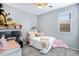 Well-lit bedroom with a ceiling fan, window with blinds, and a pink desk at 4231 E Augusta Ave, Chandler, AZ 85249