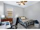Comfortable bedroom featuring a ceiling fan, window with blinds, and an office desk at 4231 E Augusta Ave, Chandler, AZ 85249