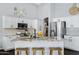Updated kitchen with granite island, pendant lighting, and stainless steel appliances at 4231 E Augusta Ave, Chandler, AZ 85249
