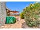 The backyard features a pergola and covered grill area with green shrubbery and a stone wall at 4363 E Dragoon Cir, Mesa, AZ 85206
