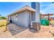 Home's backyard featuring a brick exterior with a gray chimney and low maintenance desert landscaping at 4363 E Dragoon Cir, Mesa, AZ 85206