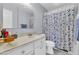 Well-maintained bathroom featuring a vanity with white cabinets, shower, and toilet at 4363 E Dragoon Cir, Mesa, AZ 85206