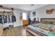 Bedroom with unique decor, wood-look floors, decorative wall art, and built-in shelving at 4363 E Dragoon Cir, Mesa, AZ 85206