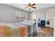 Bedroom with wood floors, ceiling fan, shuttered windows, and a colorful bedspread with a white frame at 4363 E Dragoon Cir, Mesa, AZ 85206