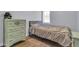 Bedroom with light gray walls, wood-look floors, and an antique dresser with a matching bed at 4363 E Dragoon Cir, Mesa, AZ 85206