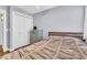 Bedroom with white trim, wood-look floors, and a beige comforter and dresser at 4363 E Dragoon Cir, Mesa, AZ 85206