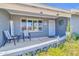 Inviting front porch with cozy seating, decorative accents, and a secure screen door at 4363 E Dragoon Cir, Mesa, AZ 85206