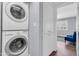 Laundry room featuring a stackable washer and dryer next to hallway at 4363 E Dragoon Cir, Mesa, AZ 85206