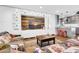 Open-concept living area with custom built-ins, modern lighting, and a seamless connection to the kitchen at 4363 E Dragoon Cir, Mesa, AZ 85206