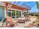 Spacious covered back patio with a seating arrangement, stone wall, and sliding glass doors at 4363 E Dragoon Cir, Mesa, AZ 85206