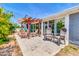 Rear covered patio with nice seating arrangement and view of the backyard with blue skies at 4363 E Dragoon Cir, Mesa, AZ 85206