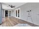 The sun room has wood-look tile floors, gray brick walls, and modern ceiling fan at 4363 E Dragoon Cir, Mesa, AZ 85206