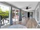 Bright sun room features wood-look tile floors and access to the outdoor patio at 4363 E Dragoon Cir, Mesa, AZ 85206
