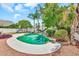 Landscaped backyard featuring a swimming pool and stone accents at 4601 E Carolina Dr, Phoenix, AZ 85032