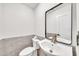 Modern powder room with gray tiled walls and updated fixtures at 4601 E Carolina Dr, Phoenix, AZ 85032