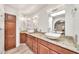 Bathroom with dual sinks, granite countertops, and modern lighting fixtures at 4601 E Carolina Dr, Phoenix, AZ 85032