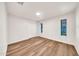 Bedroom featuring wood-look floors and windows with views at 4601 E Carolina Dr, Phoenix, AZ 85032