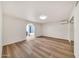 Bright bedroom featuring wood-look floors and an archway to the bathroom at 4601 E Carolina Dr, Phoenix, AZ 85032