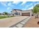 Attractive home exterior with a wide driveway, lush lawn, and neatly arranged stone walkway at 4601 E Carolina Dr, Phoenix, AZ 85032